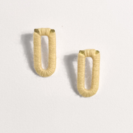 Pair of gold hoop earrings on a light gray background